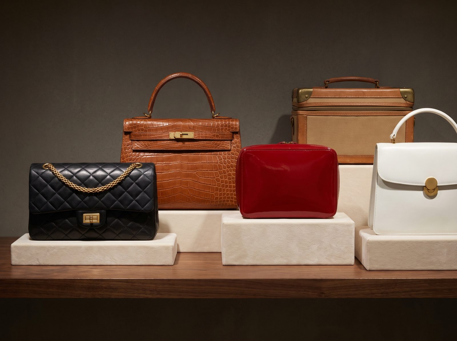 Collection of vintage leather handbags on a walnut shelf